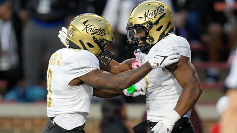Central Florida running back RJ Harvey, right, celebrates with Johnny...