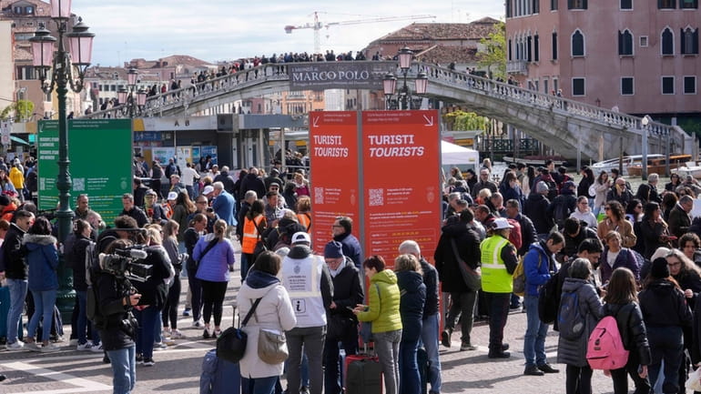 Stewards check tourists QR code access outside the main train...