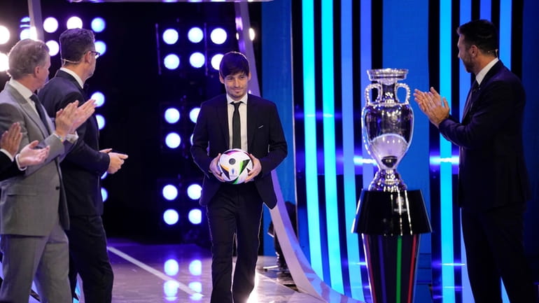 Former soccer player David Silva arrives during the draw for...