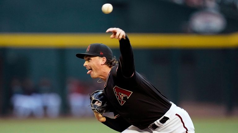 Arizona Diamondbacks starting pitcher Tommy Henry throws to a Colorado...