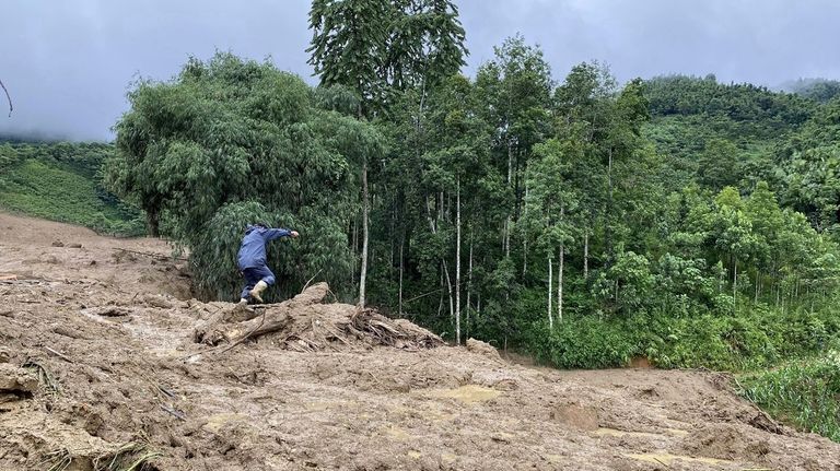 Mud and debris bury houses in Lang Nu hamlet in...