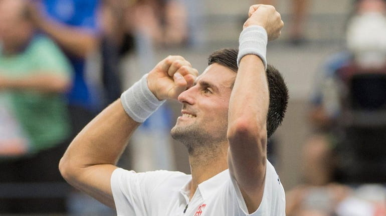 Novak Djokovic reacts after defeating Gael Monfils in a men's...