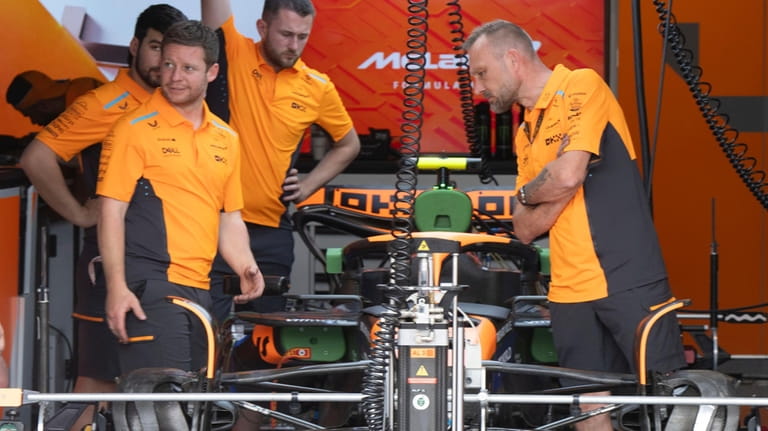 McLaren mechanics work on Land Norris' car at the Canadian...