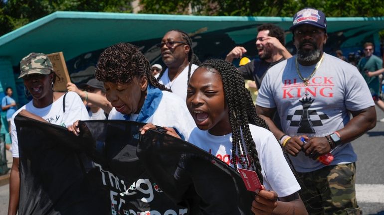 Legacy Garner, Eric Garner's youngest daughter, center, marches with family...