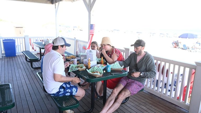 Beachgoers grab a bite at Coopers Beach in Southampton.