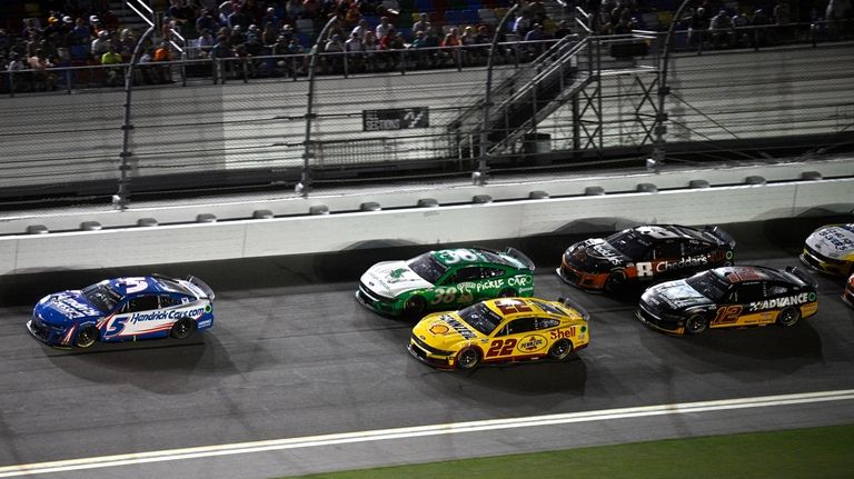 Kyle Larson (5) leads Todd Gilliland (38), Joey Logano (22),...