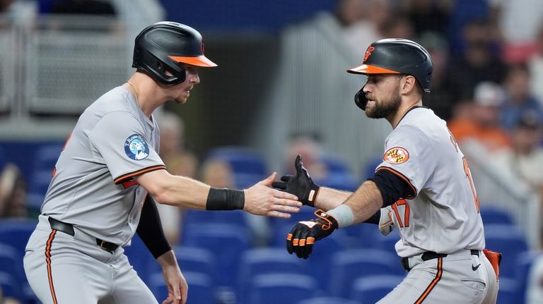 Baltimore Orioles designated hitter Ryan O'Hearn, left, congratulates Colton Cowser...