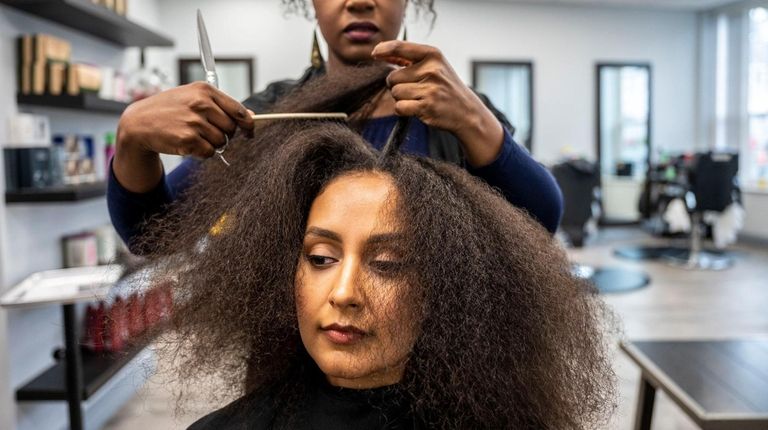 Elizabeth Rabanal, founder of Curly Culture Salon, works on Sara...