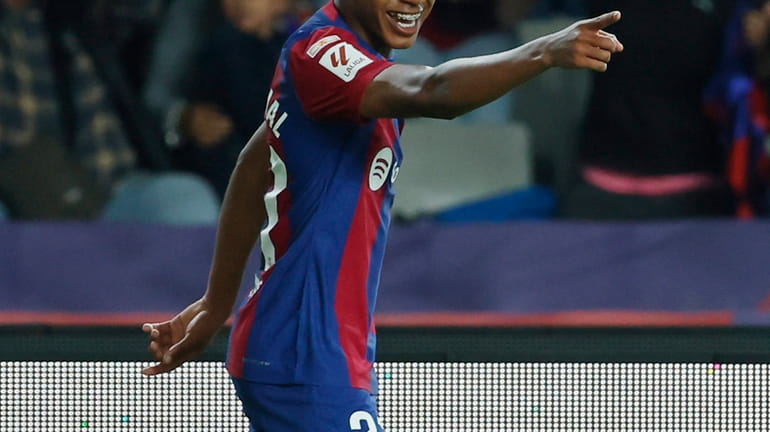 Barcelona's Lamine Yamal celebrates after scoring the opening goal during...