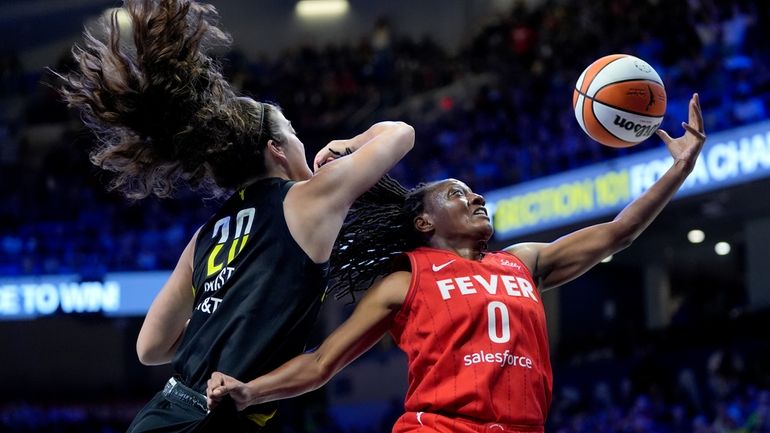 Indiana Fever guard Kelsey Mitchell (0) is blocked on a...