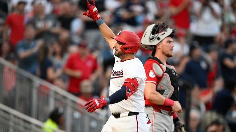 Washington Nationals' Juan Yepez, left, celebrates his three-run home run...