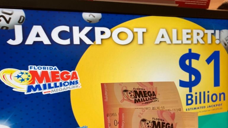 Mega Millions lottery tickets are shown at a lottery retailer in...