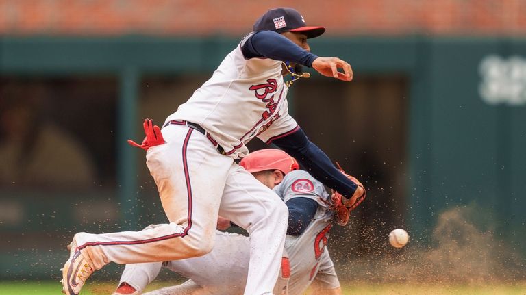 Atlanta Braves second baseman Ozzie Albies, top, attempts to tag...