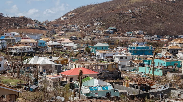 Homes destroyed by Hurricane Beryl lie in Clifton, Union Island,...