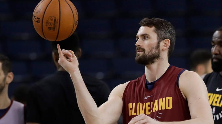 Cleveland's Kevin Love juggles a basketball during practice before the...