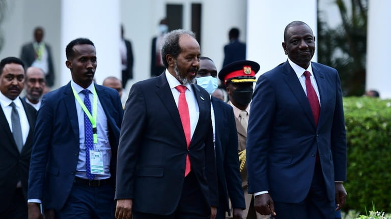 Kenya President, William Ruto, right, accompanied by Somalia President, Hassan...