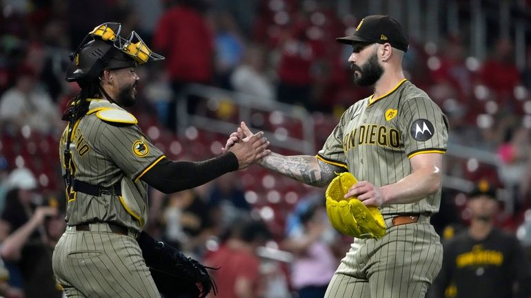 San Diego Padres pitcher Tanner Scott celebrates with catcher Luis...