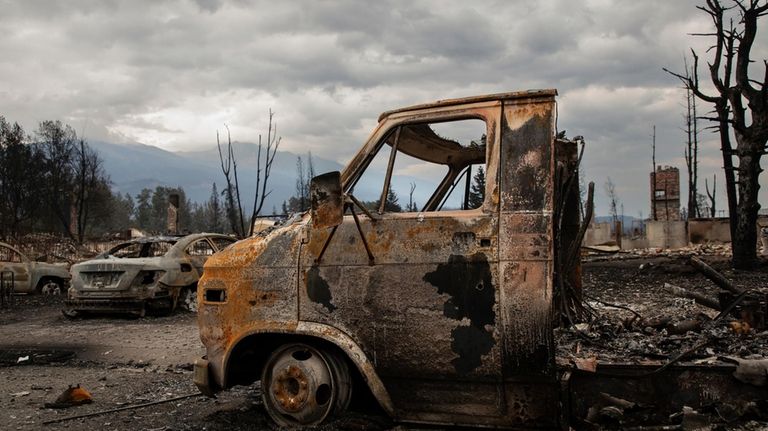 Burned out vehicles in a devastated residential block in Jasper,...