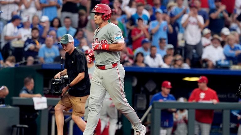 Philadelphia Phillies' J.T. Realmuto runs home after hitting a three-run...