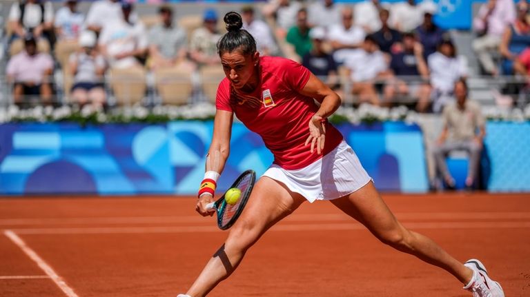 Sara Sorribes Tormo of Spain returns the ball against Barbora...