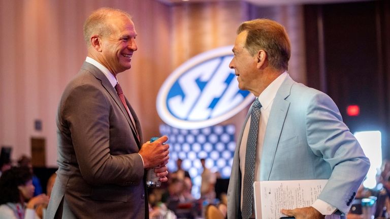 Alabama head football coach Kalen DeBoer, left, and former Alabama...