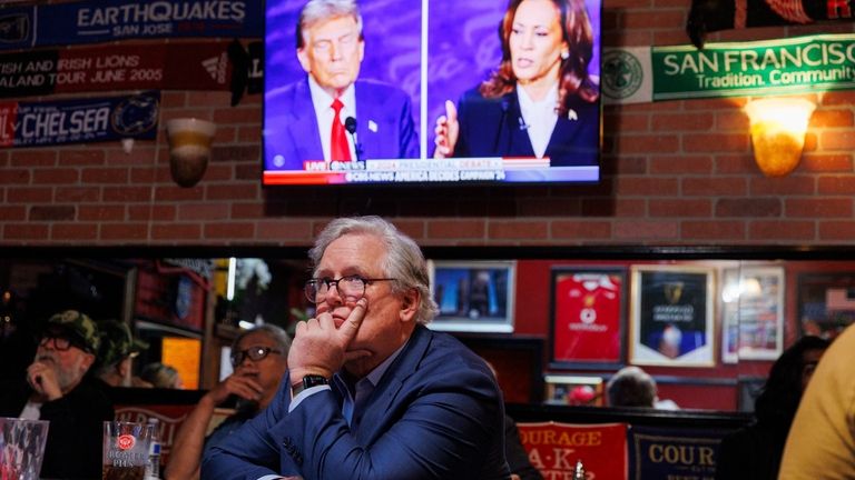 San Francisco Republican party Chair John Dennis watches a presidential...