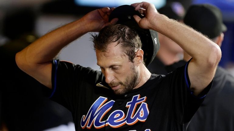 Max Scherzer of the Mets reacts in the dugout during...