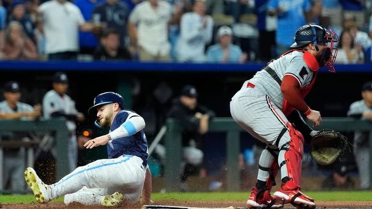 Kansas City Royals' Kyle Isbel beats the tag by Minnesota...