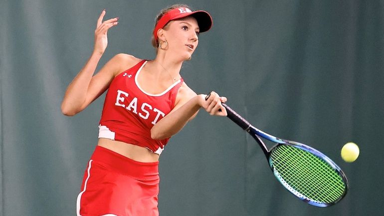 Smithtown East's Anya Konopka returns the serve in her singles...