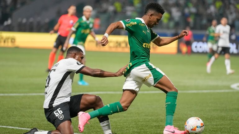 Estevao Willian of Brazil's Palmeiras, right, is challenged by Cuiabano...