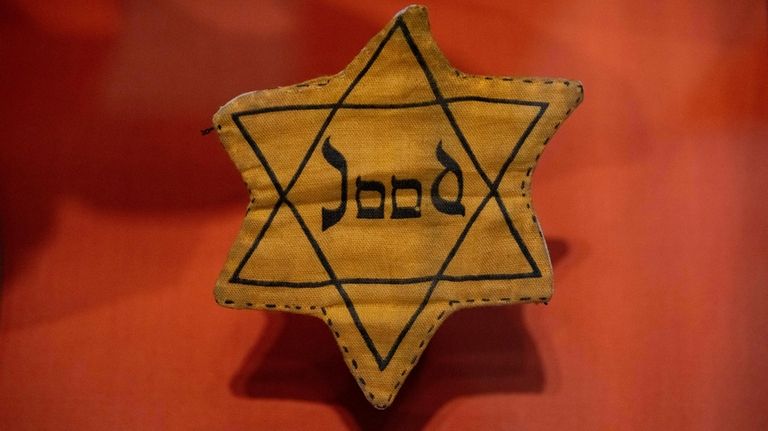 A Star of David badge with the Dutch word "Jood",...