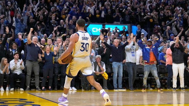 Golden State guard Stephen Curry  celebrates with the crowd in...