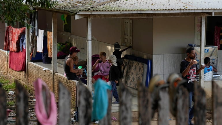 Venezuelan migrants eat breakfast at a shelter in Assis, Brazil,...