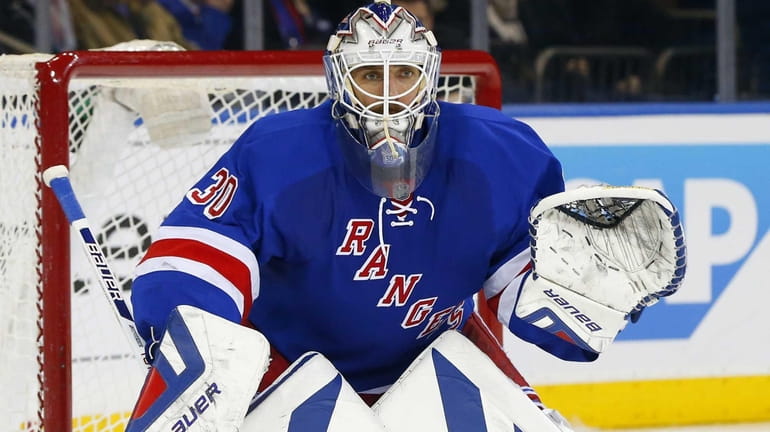 Henrik Lundqvist defends his net in the second period of...