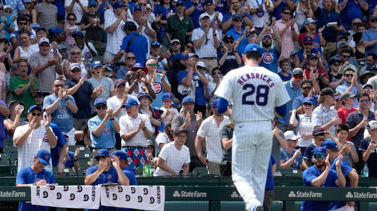 Chicago Cubs fans cheer Chicago Cubs pitcher Kyle Hendricks as...