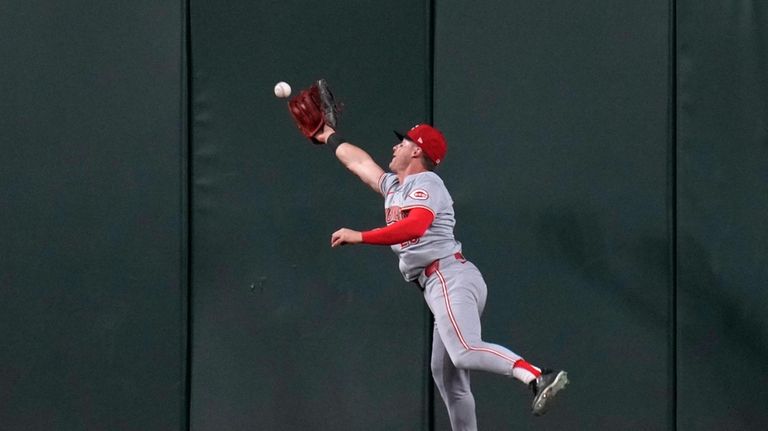 Cincinnati Reds center fielder TJ Friedl is unable to reach...