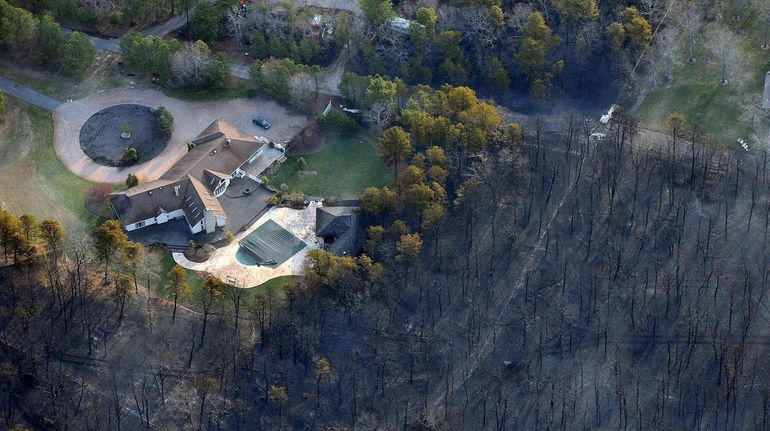 Flames reached the guesthouse behind a home near Wading River...