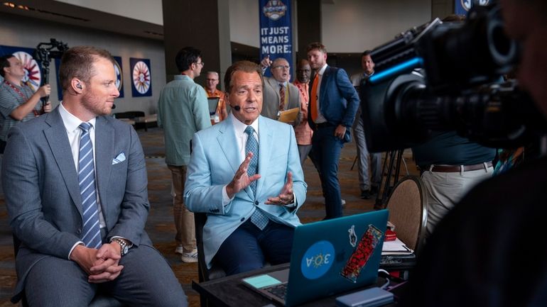 ESPN commentators Nick Saban, right, and Greg McElroy speak during...