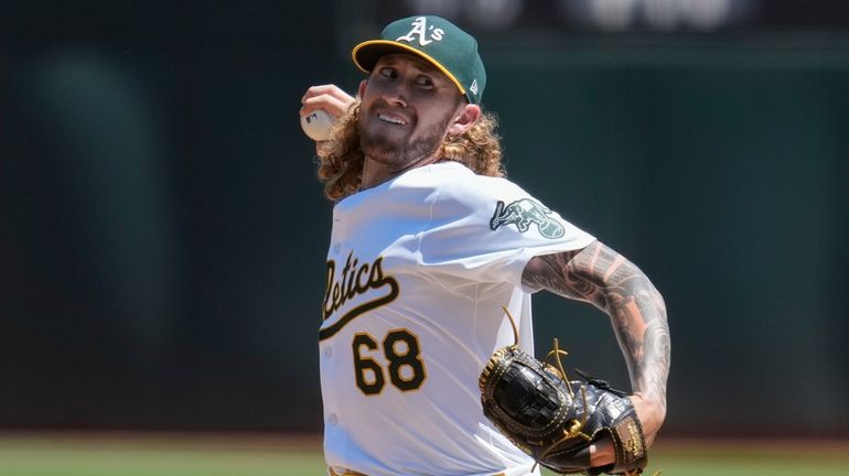 Oakland Athletics' Joey Estes pitches to a Milwaukee Brewers batter...