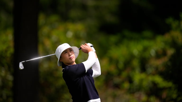 Amy Yang, of South Korea, watches her shot after hitting...