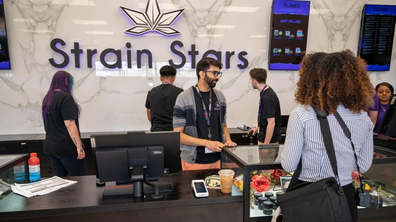 Customers purchase legal cannabis at Strain Stars, Long Island's only...