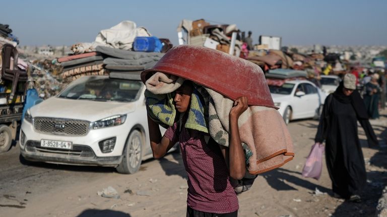 A Palestinian youth flees the Khan Younis area of the...