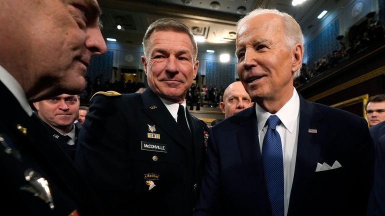 President Joe Biden talks to guests after delivering his State...