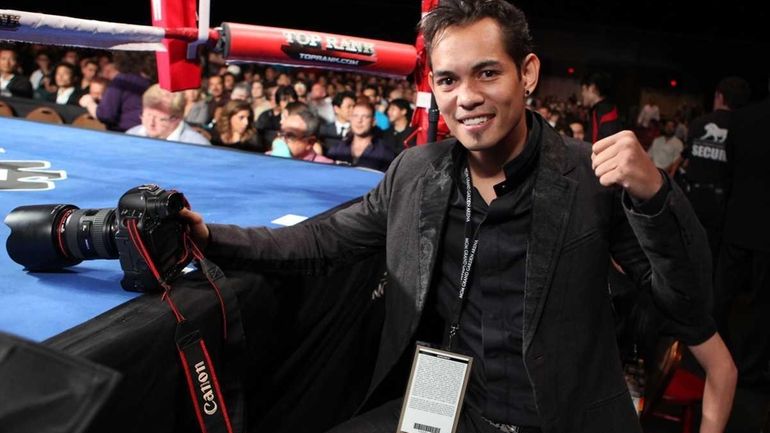 Boxer Nonito Donaire sits ringside and takes photos while Toshiaki...