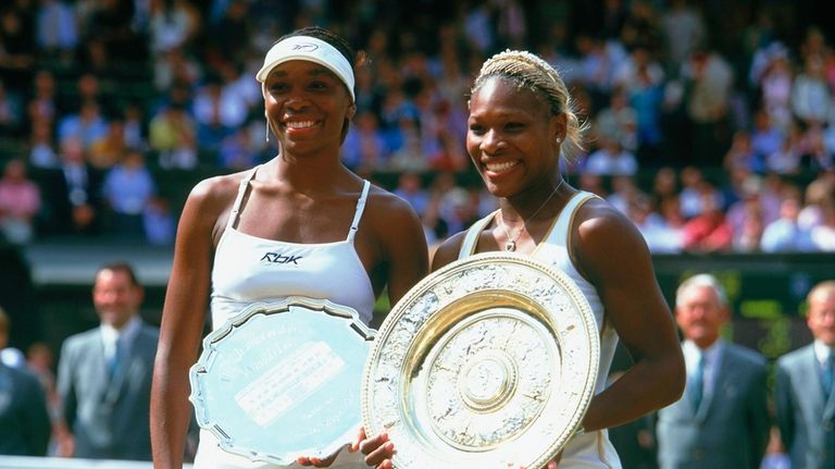 Wimbledon champion Serena Williams (right) poses with the winning trophy...