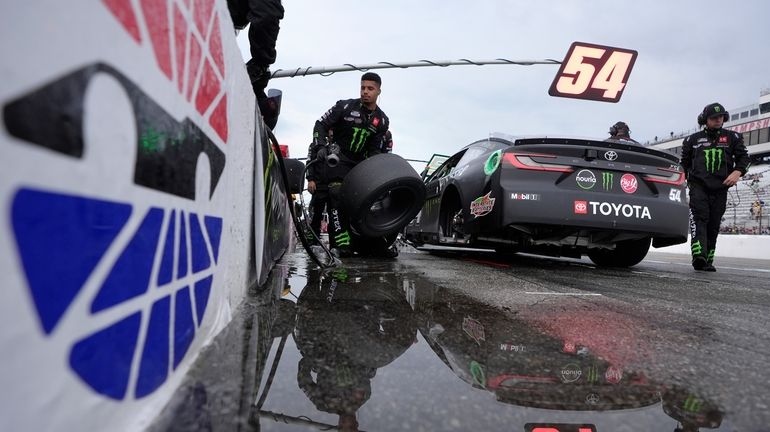 Pit crew for Ty Gibbs (54) work on the car...