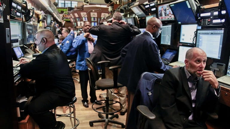 Traders prepare for the start of early trading at the...