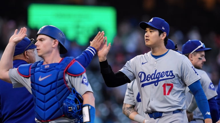 Los Angeles Dodgers' Shohei Ohtani, right, celebrates with manager Dave...