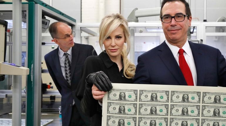 Treasury Secretary Steven Mnuchin and his wife, Louise Linton, hold...