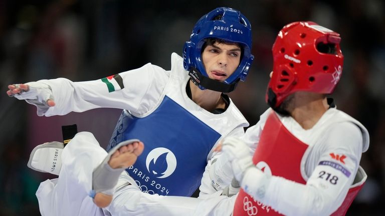 Palestine's Omar Yaser Ismail, left, competes with Refugees Olympic Team's...